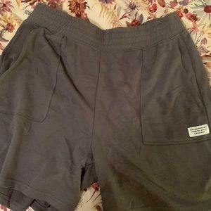 gray shorts. “this garment was made for you in a kind way” on the left pocket